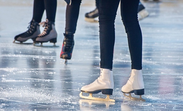 Lower legs of skaters on ice
