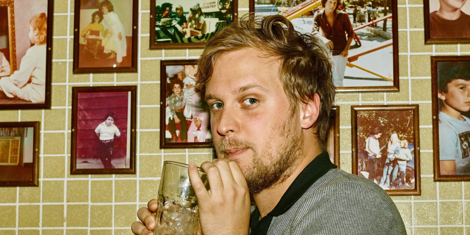 John Early sipping a drink