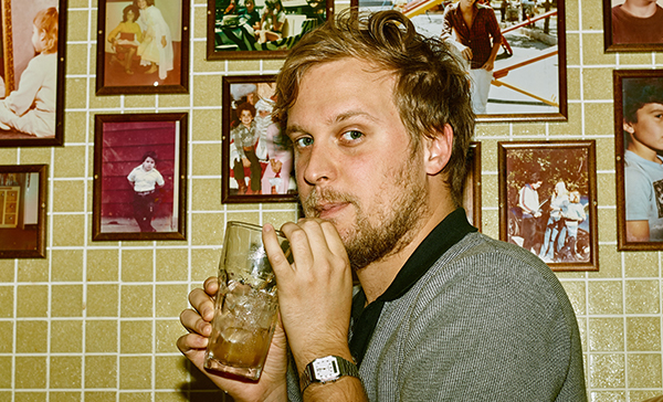 John Early sipping a drink