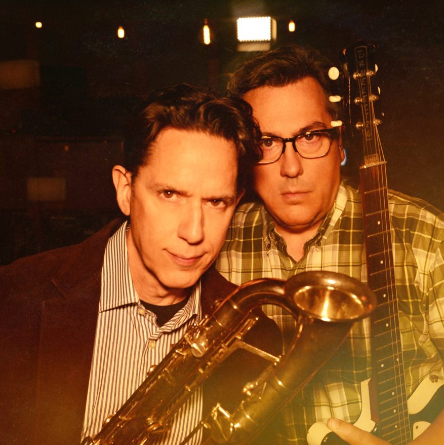 They Might Be Giants holding a tuba and guitar