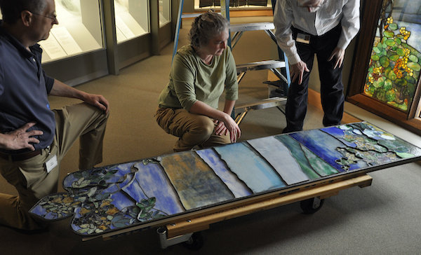 Diane Rousseau Conservation, three people looking at a stained glass panel
