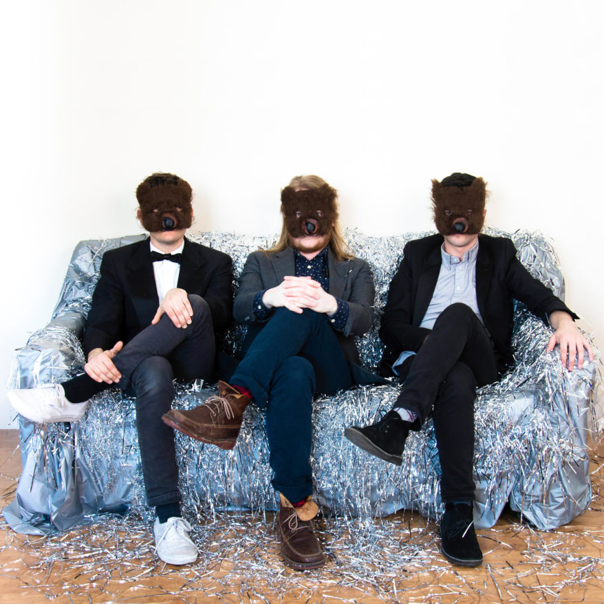 Bearthoven residency at MASS MoCA, image of trio sitting on a couch with bear masks on