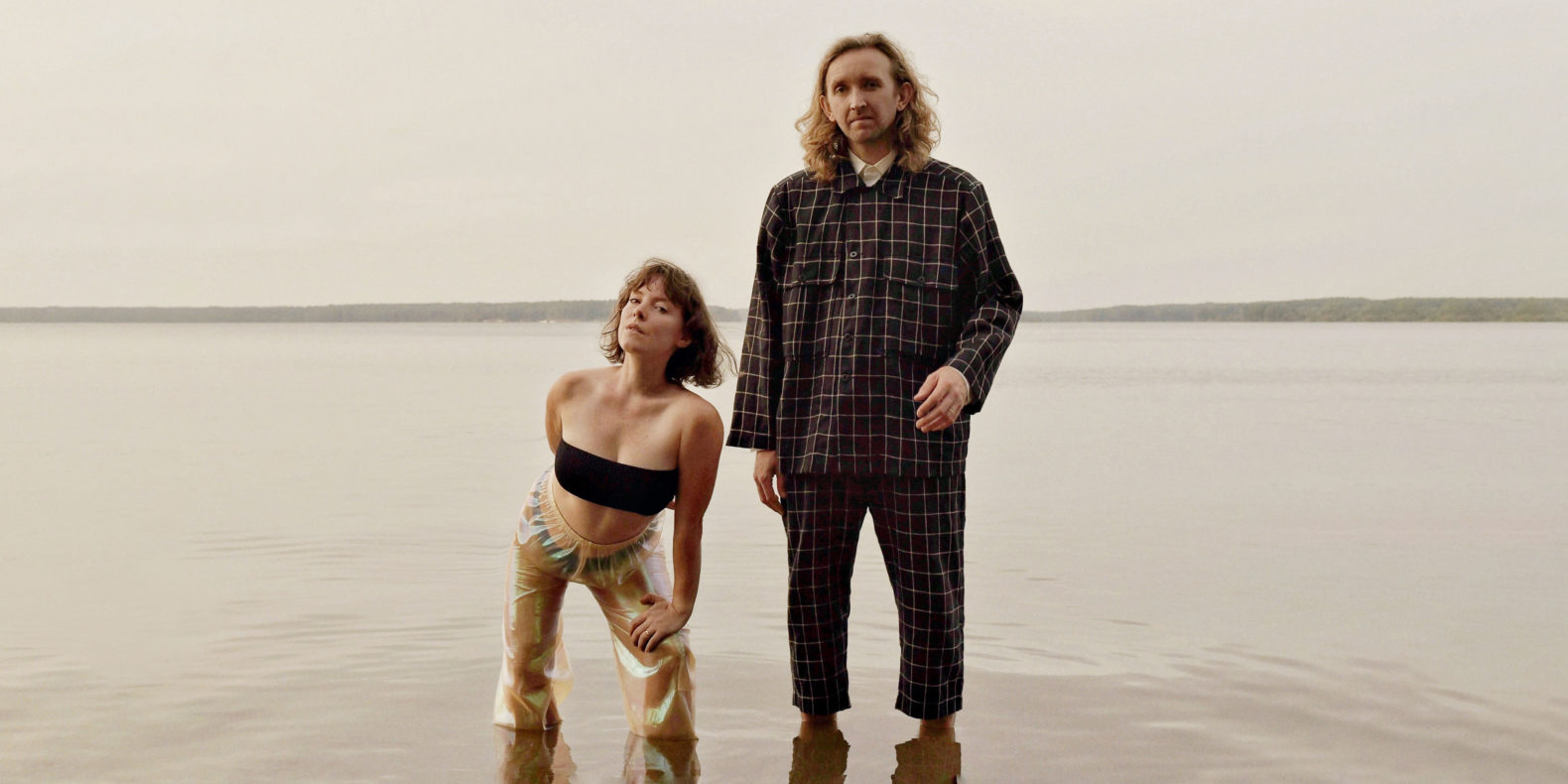 Sylvan Esso, singer Amelia Meath and producer Nick Sanborn, standing in a lake