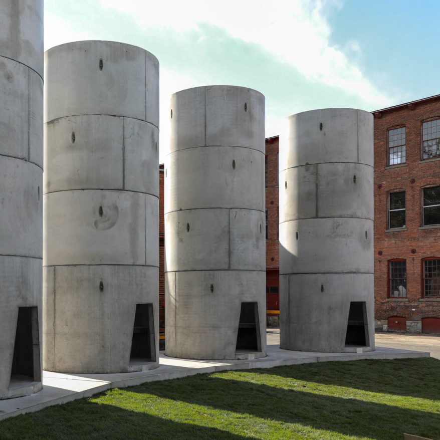 Taryn Simon: The Pipes feature image, large cement towers with doors to enter arranged in semi-circle