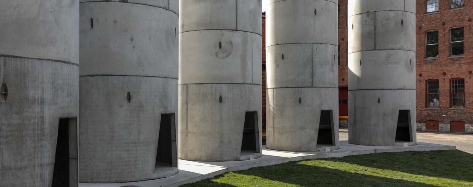 Taryn Simon: The Pipes feature image, large cement towers with doors to enter arranged in semi-circle
