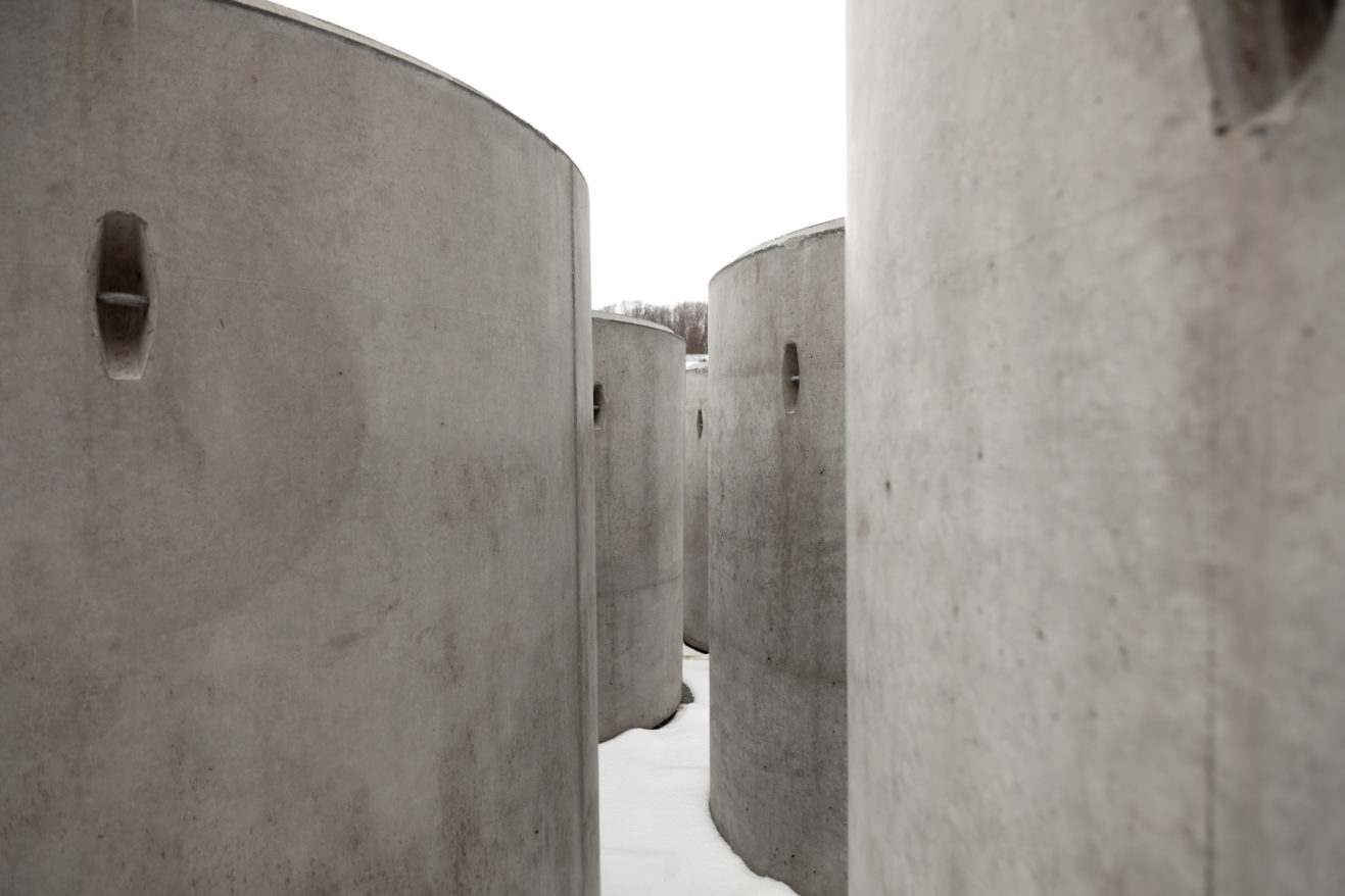 Taryn Simon The Pipes feature image, large concrete cylinders in the snow pre-install