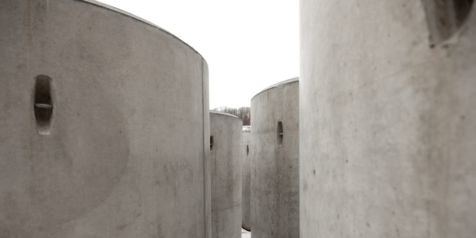 Taryn Simon The Pipes feature image, large concrete cylinders in the snow pre-install
