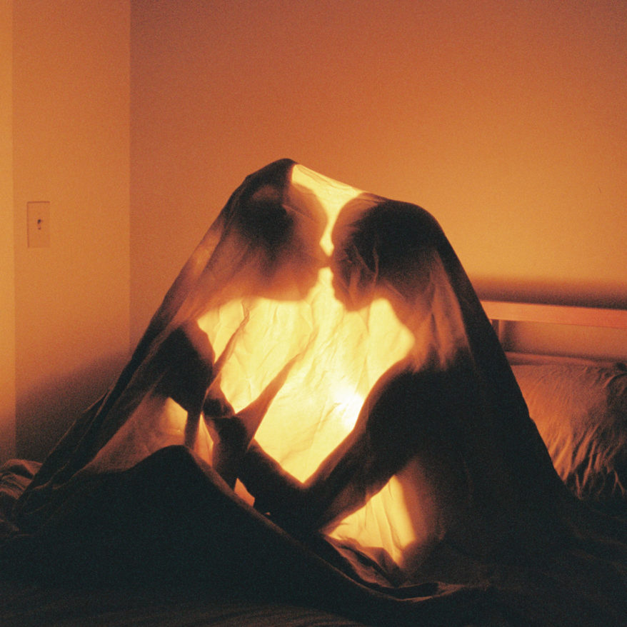 Close to You feature image, two people illuminated under a sheet