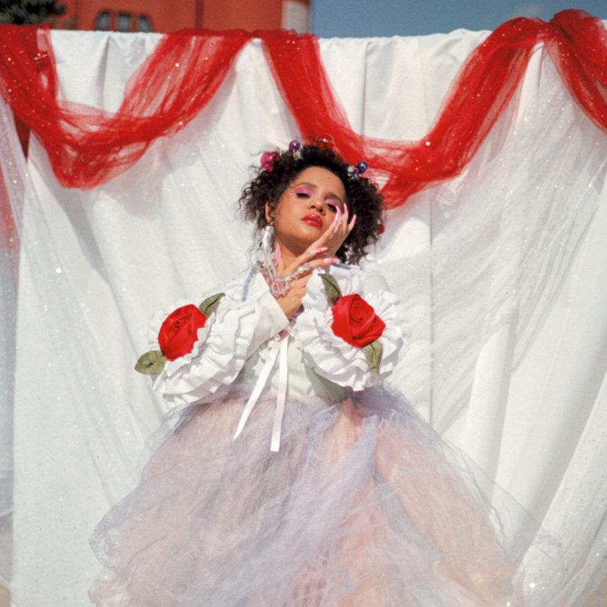 Feature image Lido Pimienta at MASS MoCA, Lido Pimienta wearing a pastel tulle dress against white background