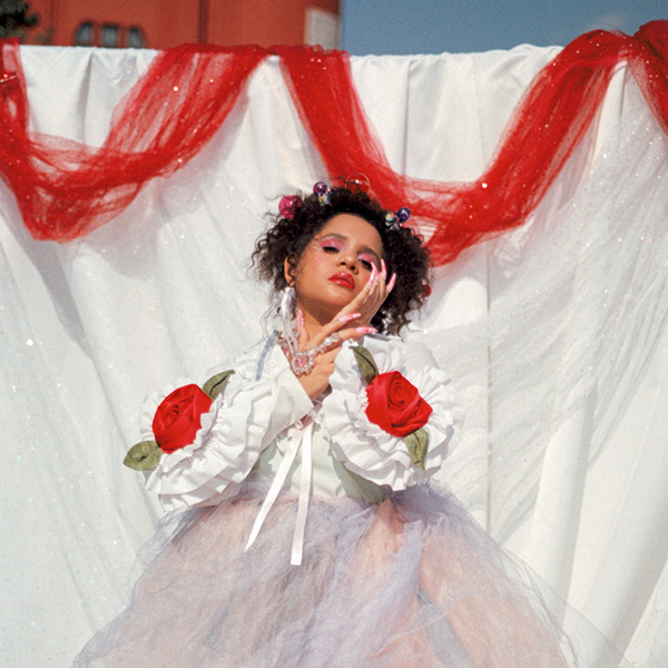 Feature image Lido Pimienta at MASS MoCA, Lido Pimienta wearing a pastel tulle dress against white background
