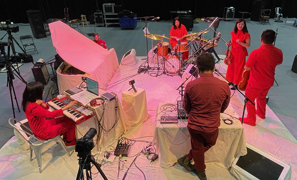Yuka Honda & Susie Ibarra featured image, musicians dressed in red on white stage