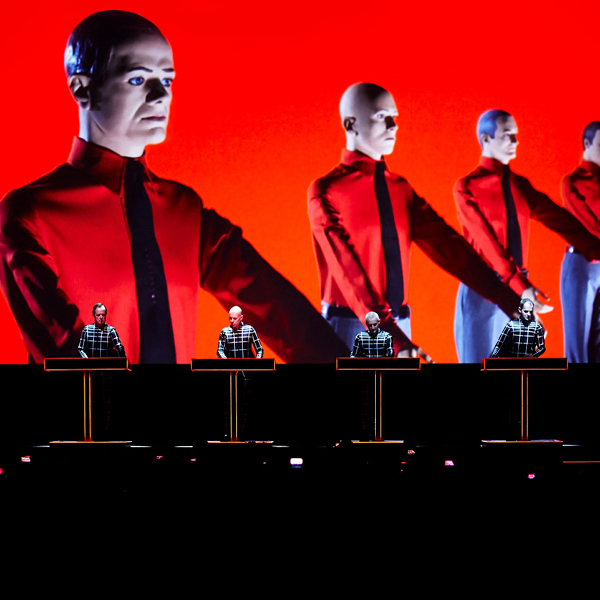 Kraftwerk at MASS MoCA feature image, band members performing on stage in front of red screen
