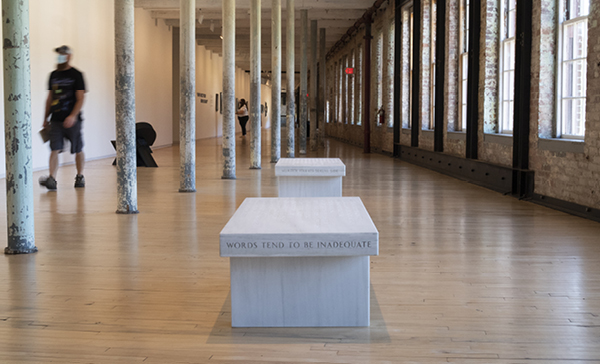 Side view of Jenny Holzer Bench reading "Words tend to be inadequate"
