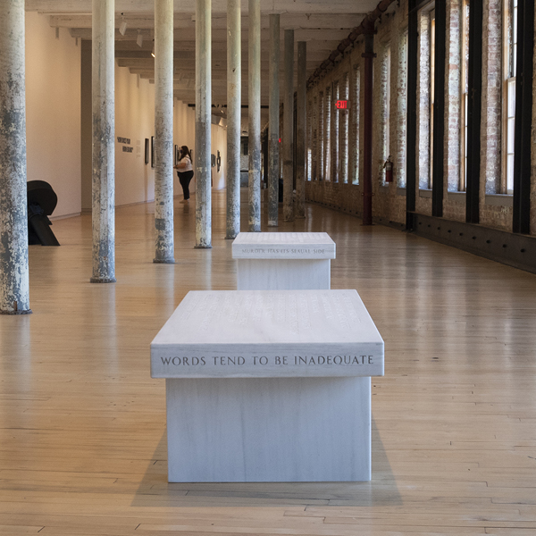 Side view of Jenny Holzer Bench reading "Words tend to be inadequate"